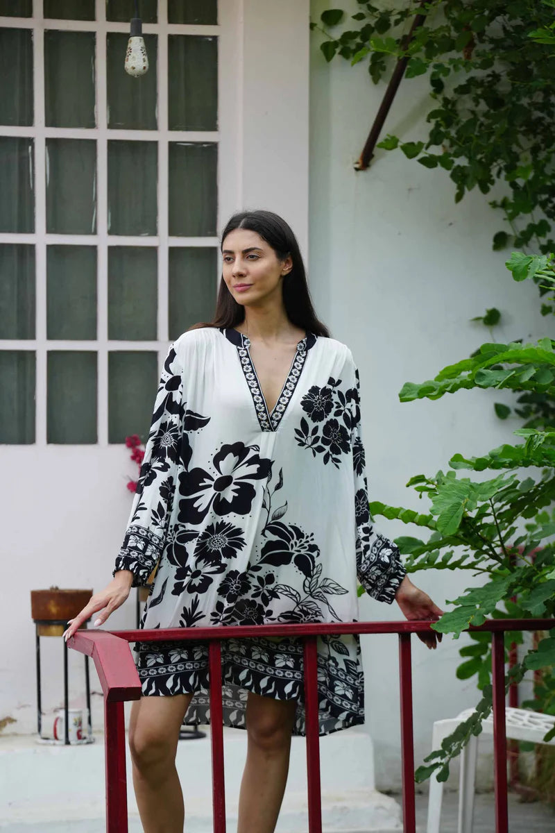 woman wearing long sleeve white with black print mini dress