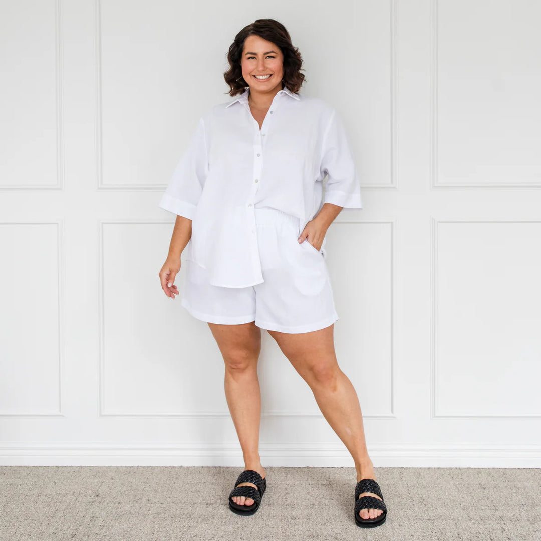 plus size woman wearing white top and shorts