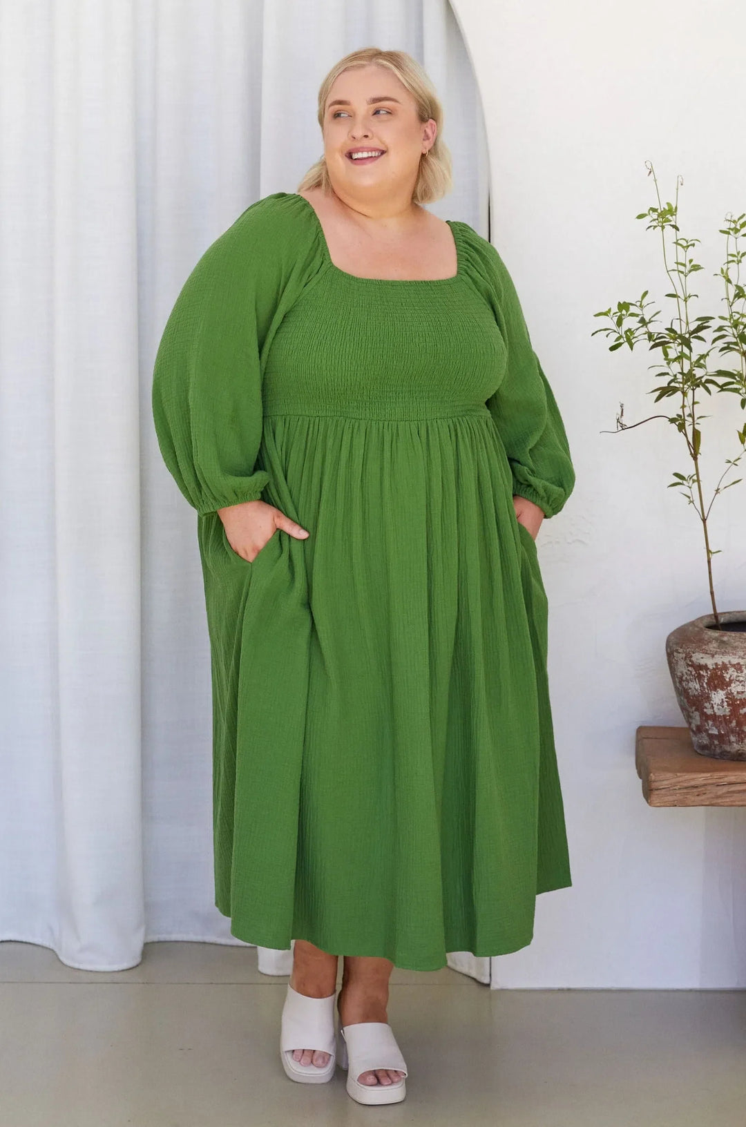plus size woman wearing long sleeve green maxi dress