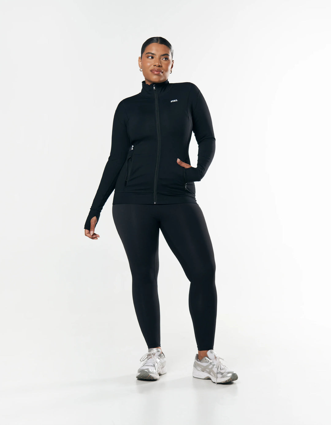 plus size woman wearing black jacket and leggings