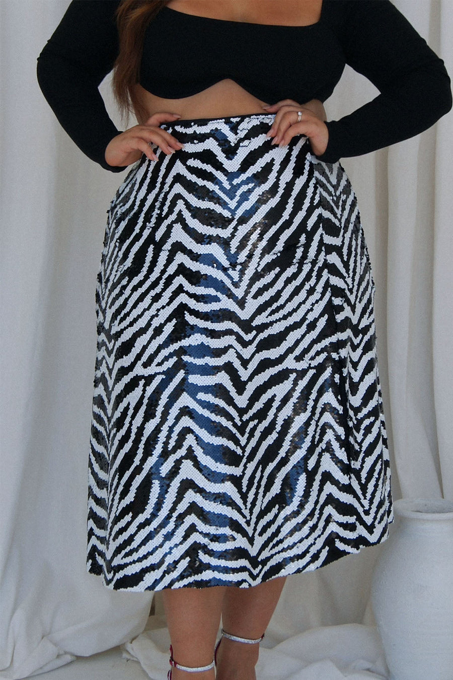 Plus size model wearing plus size zebra print sequin skirt