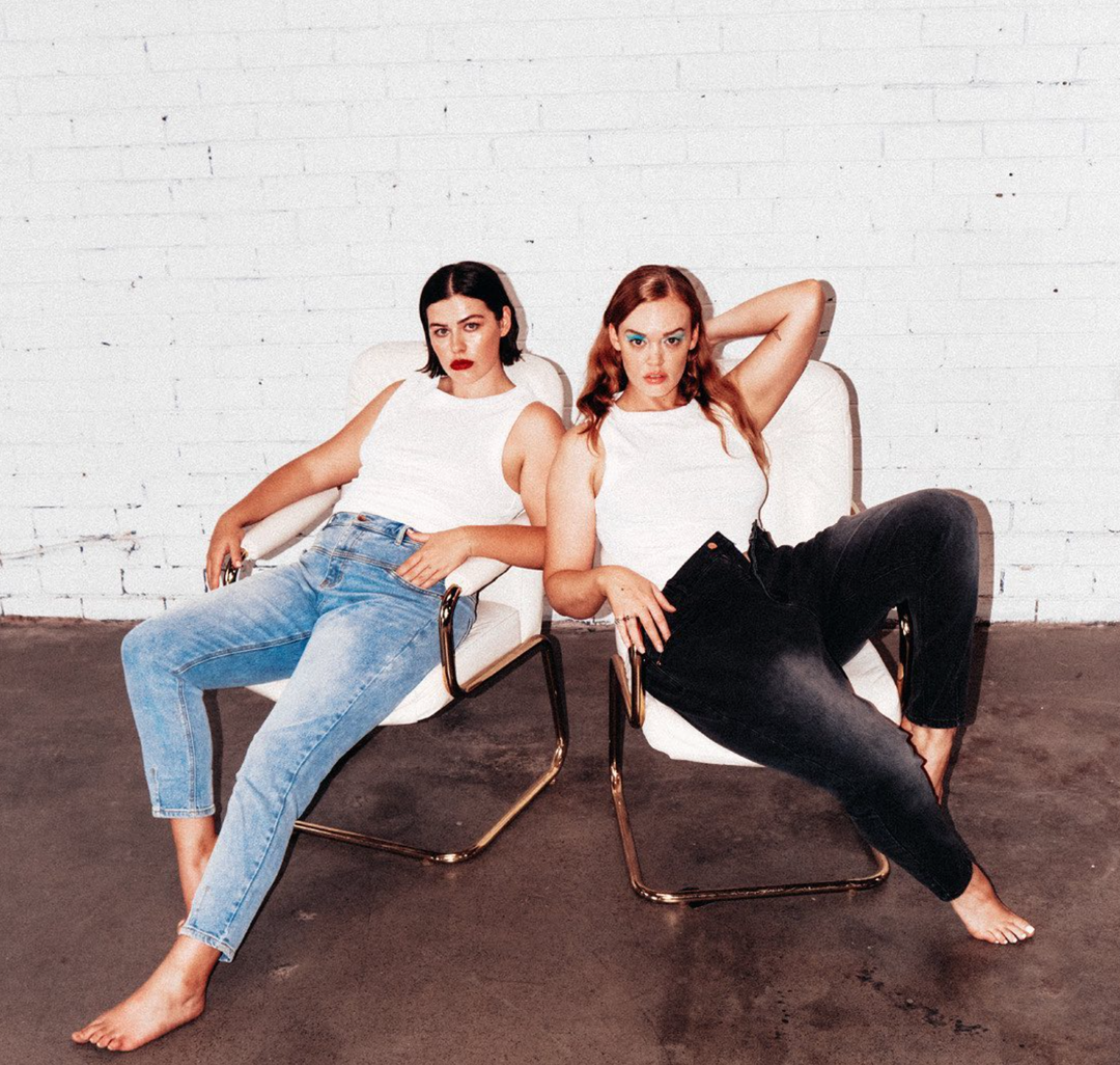 two man in white sleeveless top and denim jeans