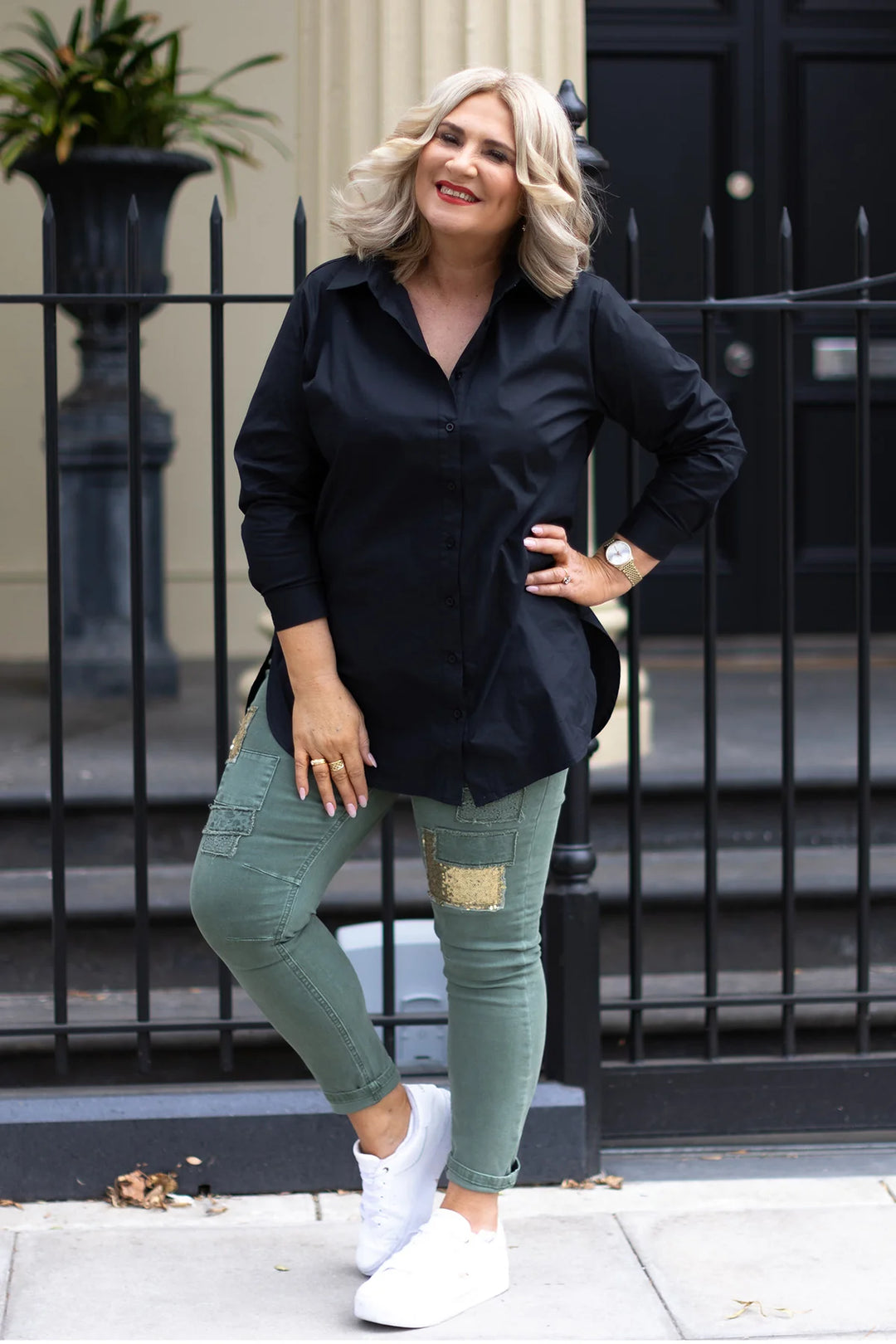 plus size woman wearing black long sleeve top and denim pants