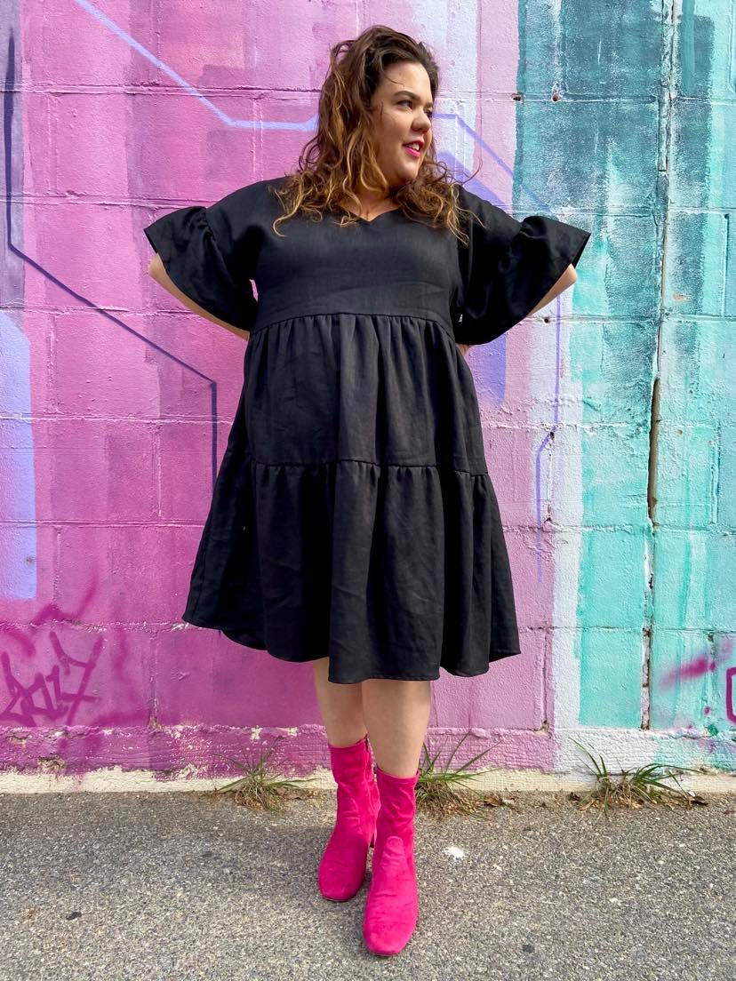 plus size woman wearing black midi dress