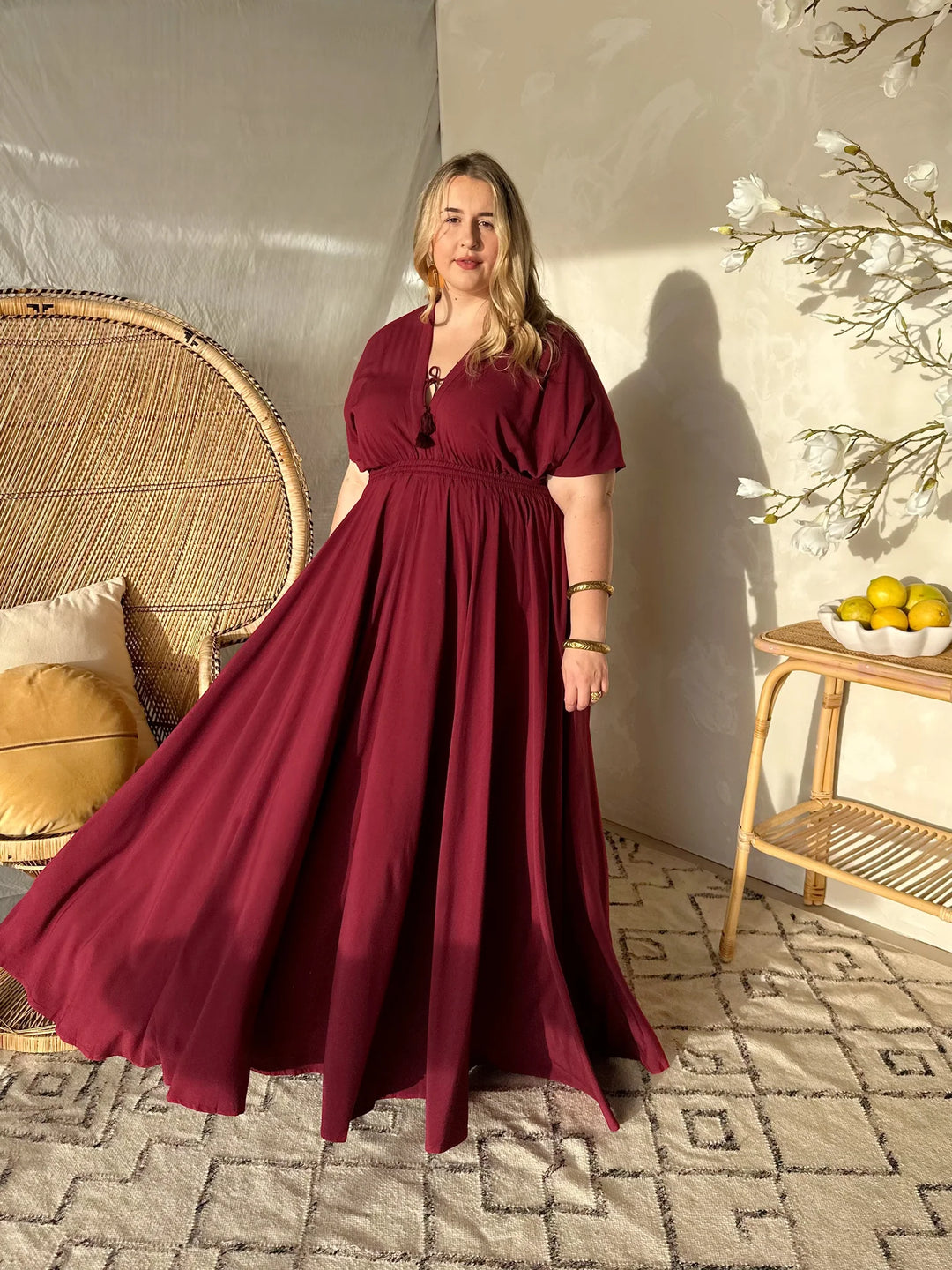 plus size woman wearing maroon maxi dress