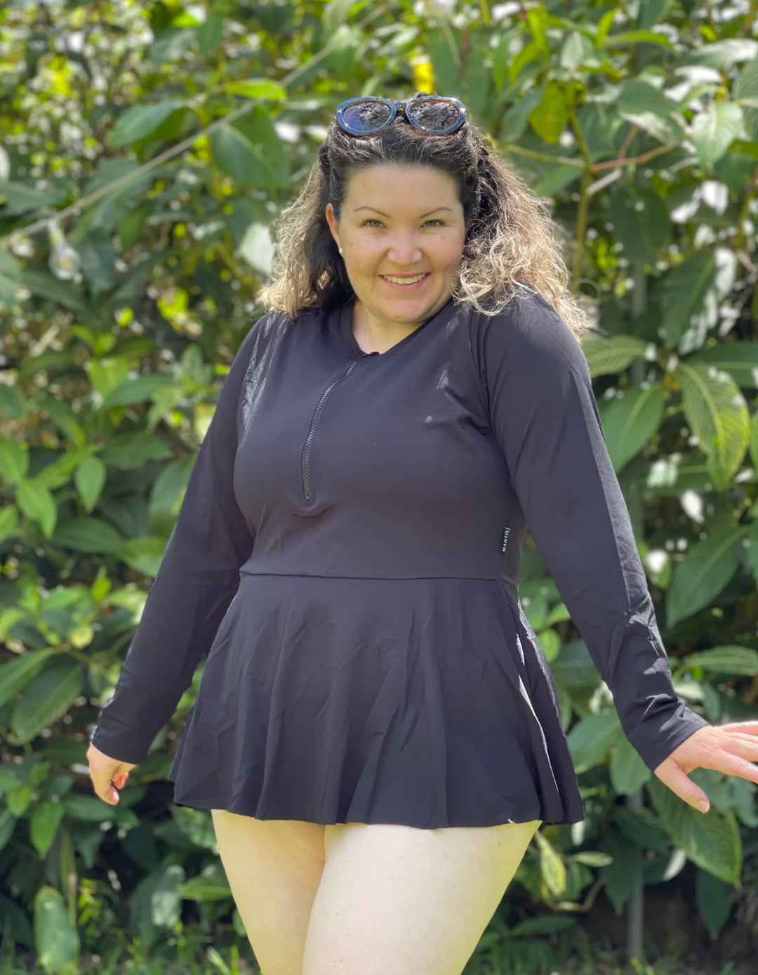 plus size woman wearing black long sleeve swimwear