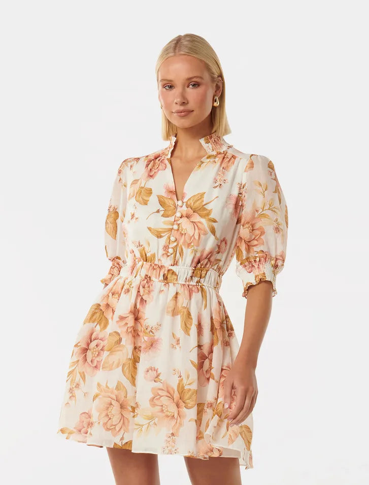 woman wearing mini floral dress with puff sleeves