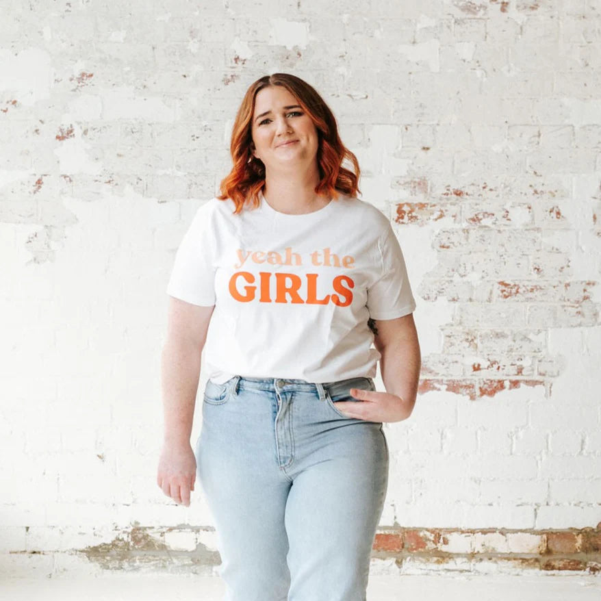 plus size woman wearing white t shirt and denim pants