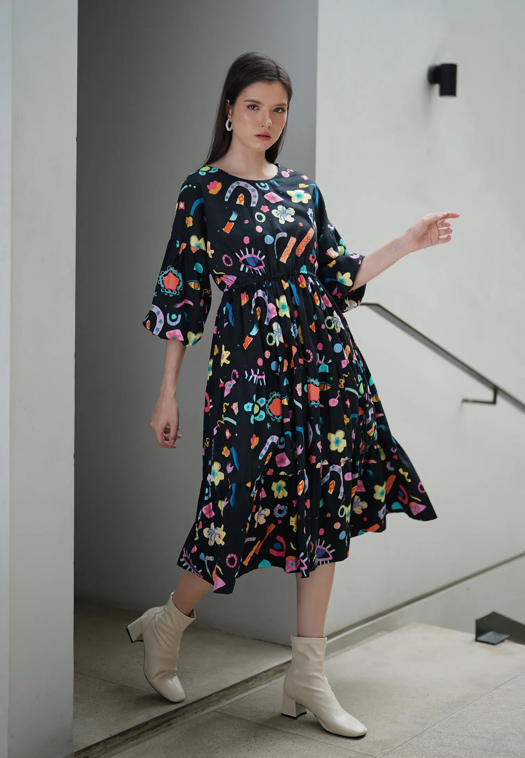 woman wearing printed black midi dress