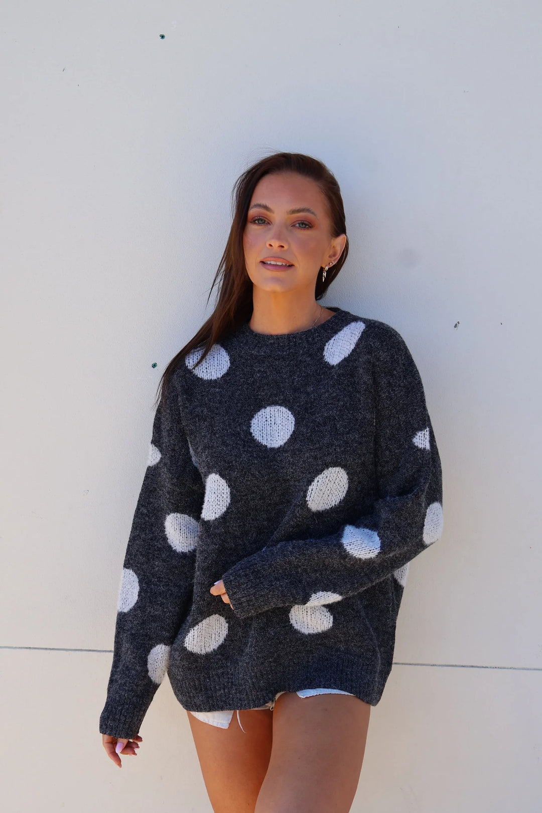 woman wearing black jumper with white polka dots