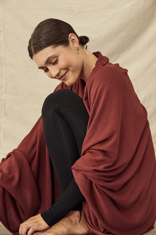 woman wearing black top and pants with maroon cover