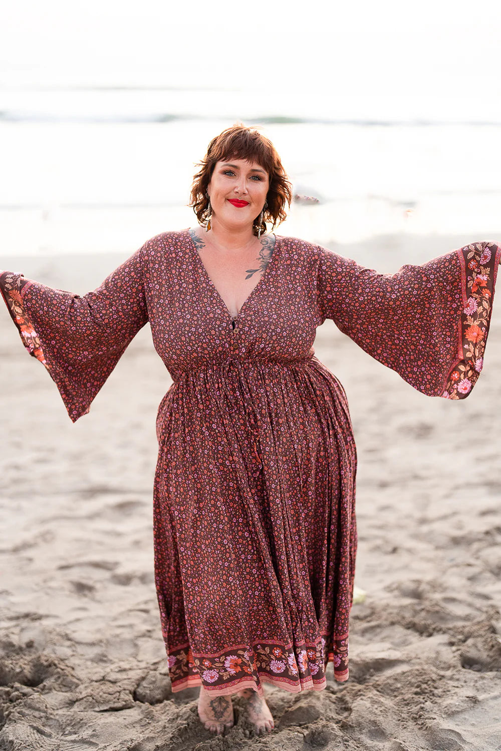 plus size woman wearing maxi dress with flutter long sleeve 