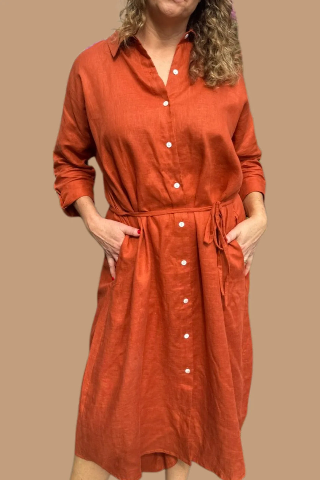 woman wearing long sleeve orange midi dress