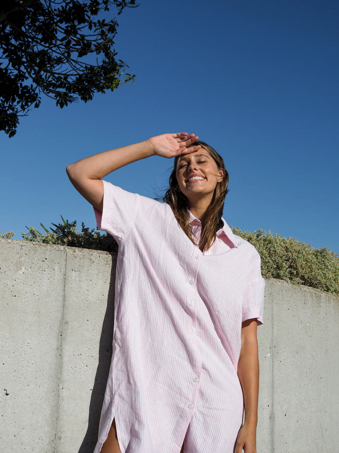 woman wearing pink white stripe button down short sleeve top