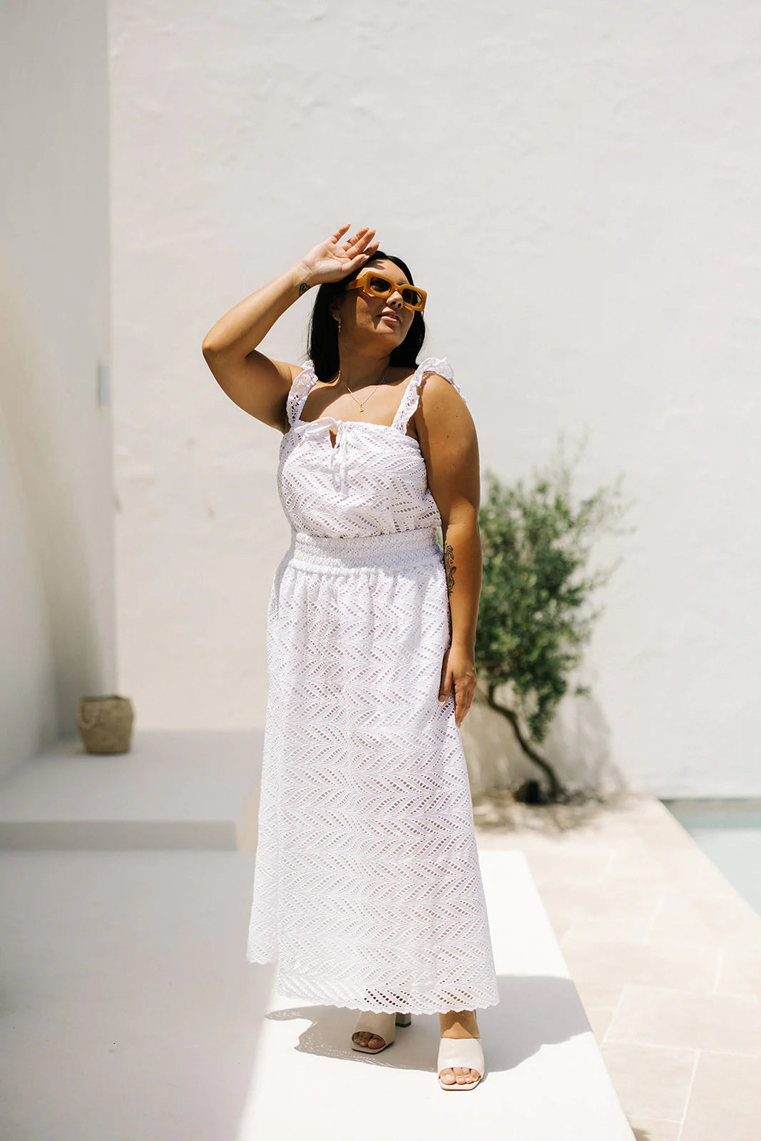 plus size woman wearing white sleeveless top with partner maxi skirt