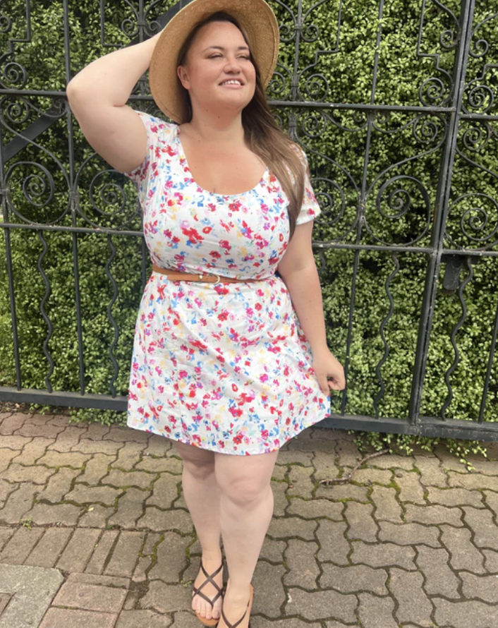 plus size woman wearing mini white floral dress