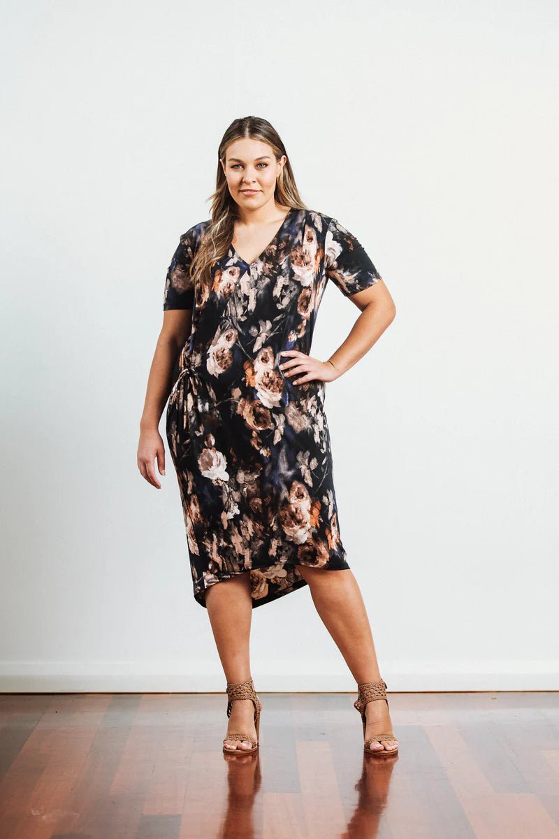 plus size woman wearing black midi with flower print dress