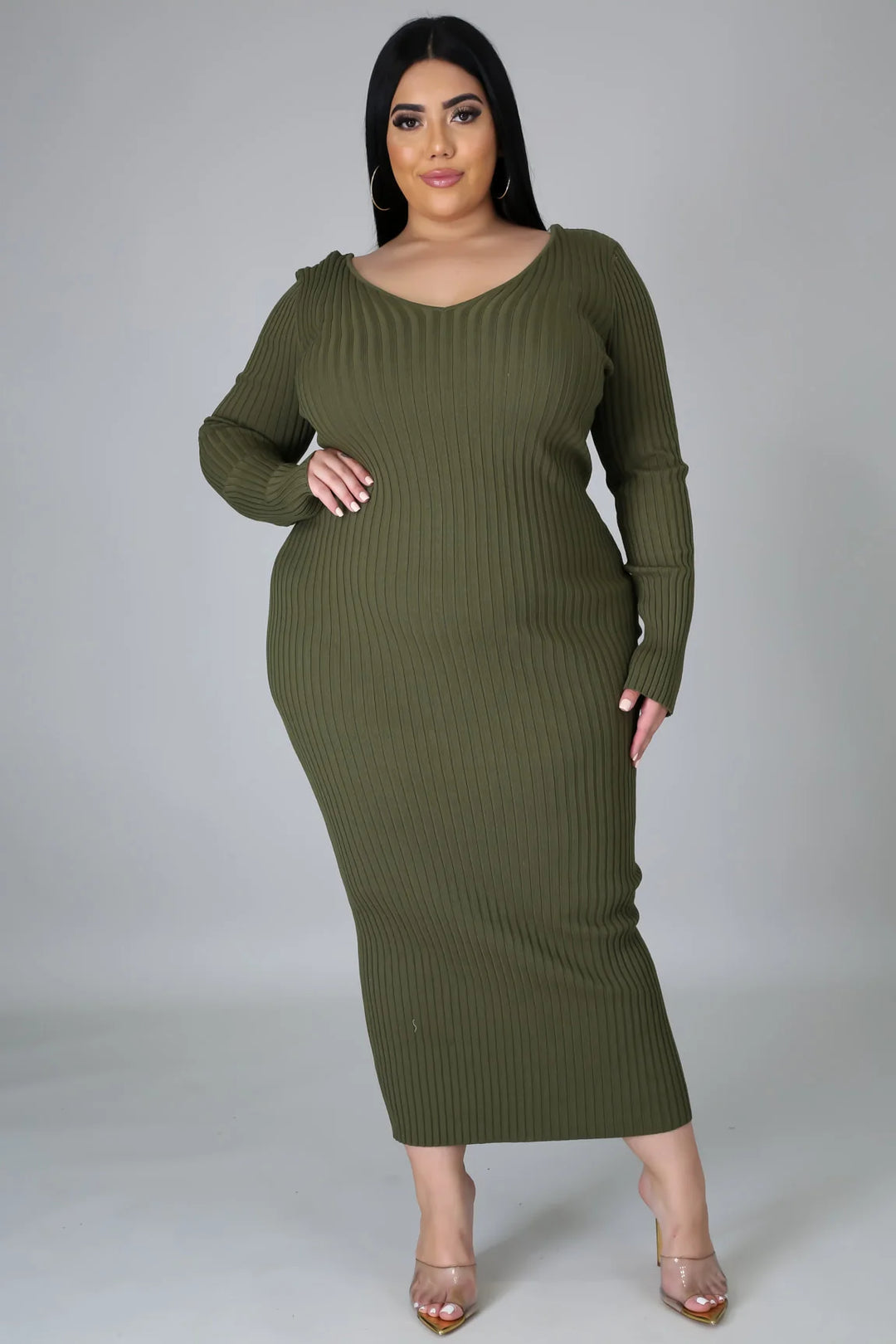 plus size woman wearing sage green ribbed body con dress